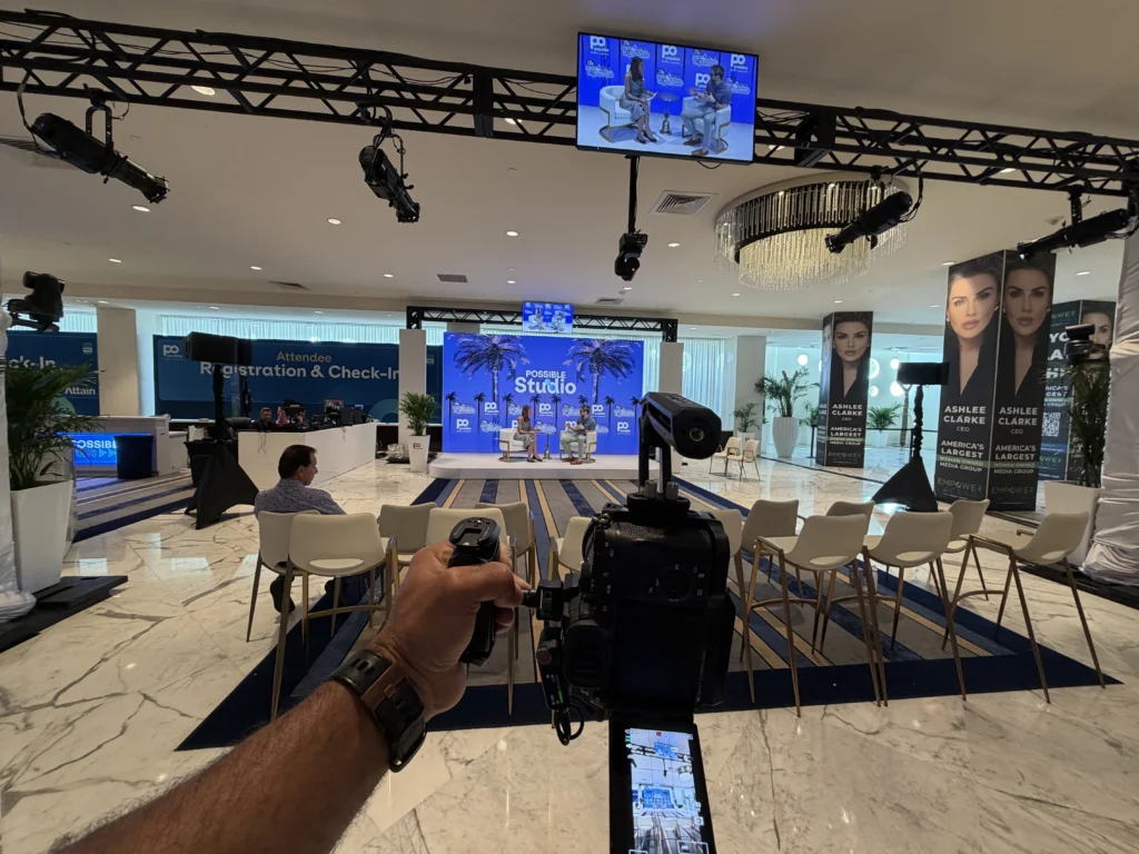 Miami videographer filming an indoor event with a camera stabilizer, illustrating Art Basel and Miami Art Week video production.